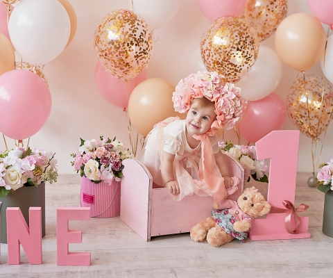 Smash cake party. Little cheerful birthday girl with first cake. Happy infant baby celebrating his first birthday. Decoration and photo zone for first year. One year baby celebration. Pink decor.